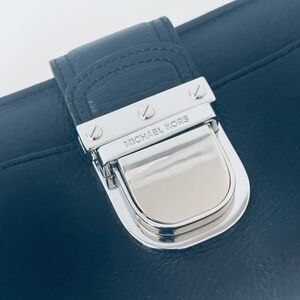 Michael Kors Black Leather Clutch Wallet with Silver clasp closure.